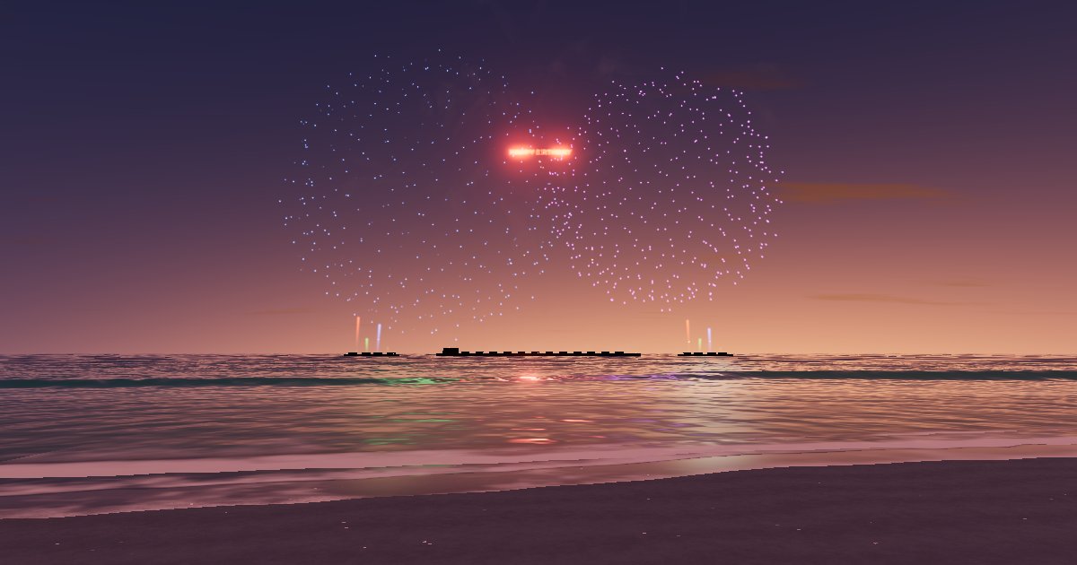 Soft, pale fireworks over a calm beach at sunset
