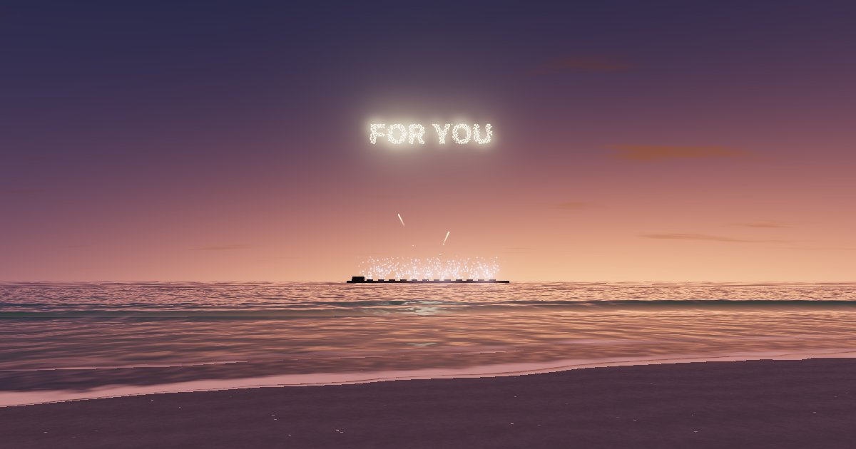 The words FOR YOU spelled in glowing sparks over a beach at sunset