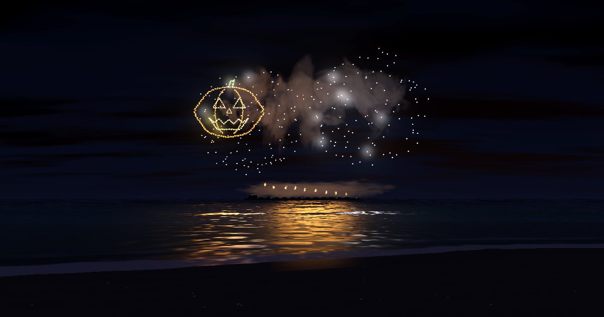 A glowing jack-o’-lantern drawn in firework sparks over a dark beach at night